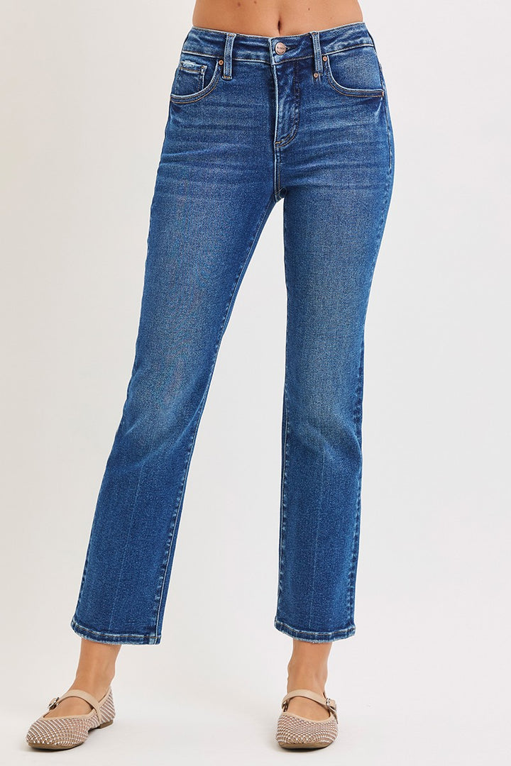 Blue jeans worn by a person on a white background