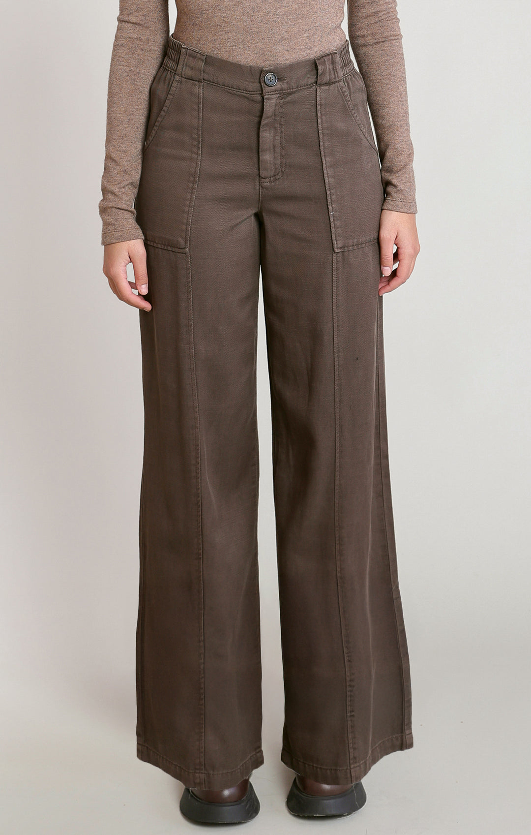 Brown wide-leg pants worn by a person on a plain background