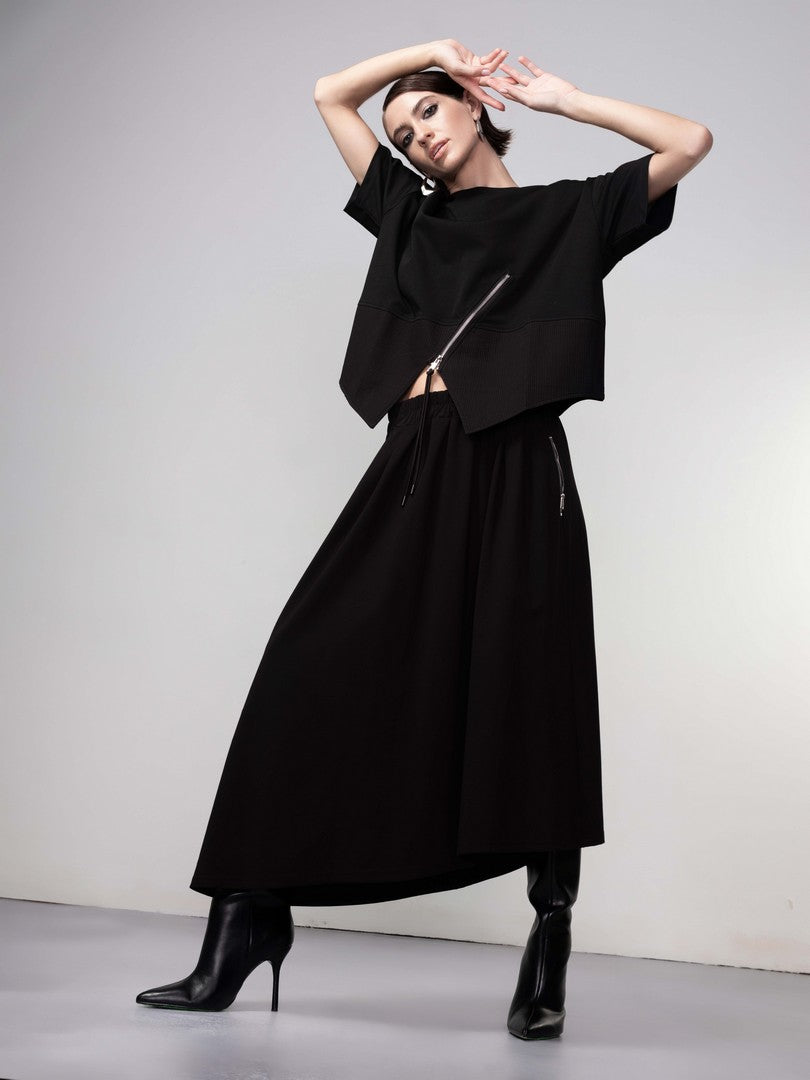 Woman wearing a black outfit with a white background