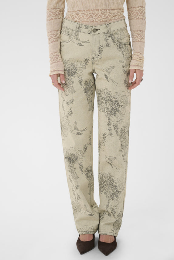 Person wearing floral-patterned pants on a white background