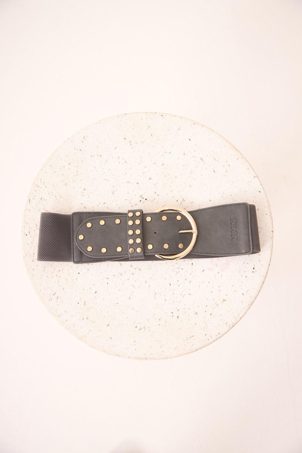 Black belt with gold studs and buckle on a white background