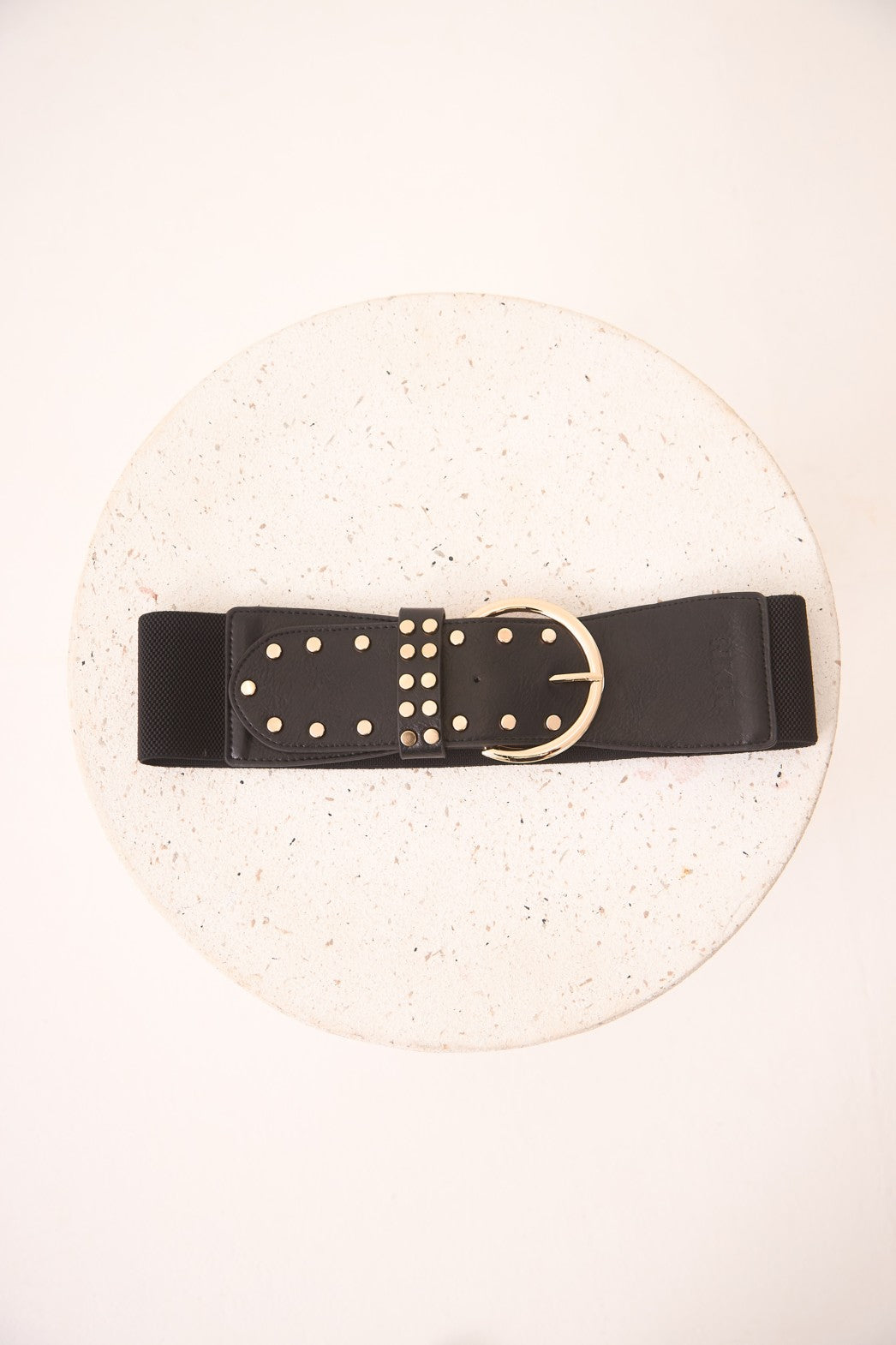 Black belt with gold studs and buckle on a white background