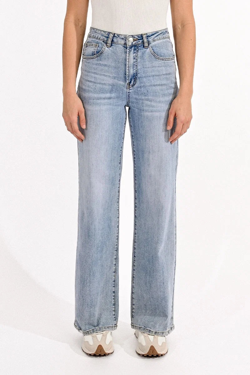 Light blue jeans worn by a person on a white background