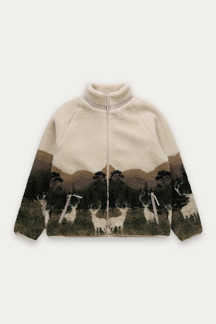 A cream-colored fleece zip-up jacket featuring a scenic landscape print on the lower half, showing deer and mountains, laid flat against a light gray background.
