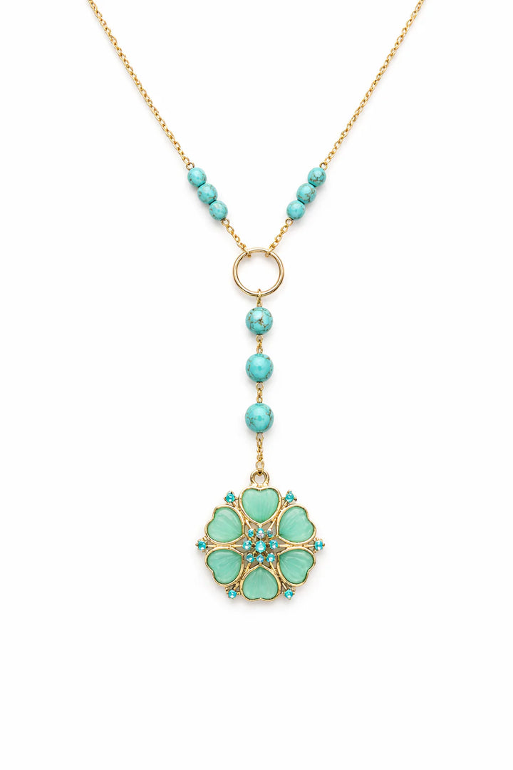 Turquoise beaded necklace with a floral pendant on a white background
