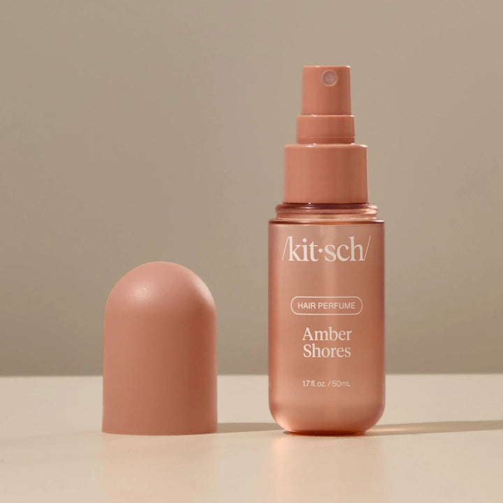 Kit-sch Amber Shores hair perfume bottle on a beige background