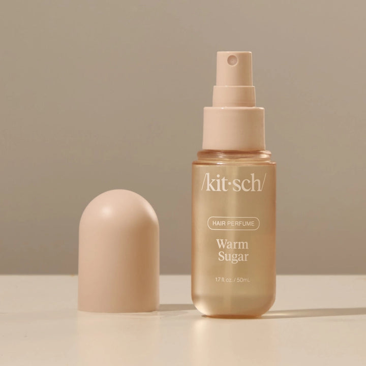 Kitsch Warm Sugar hair perfume bottle with cap on a neutral background