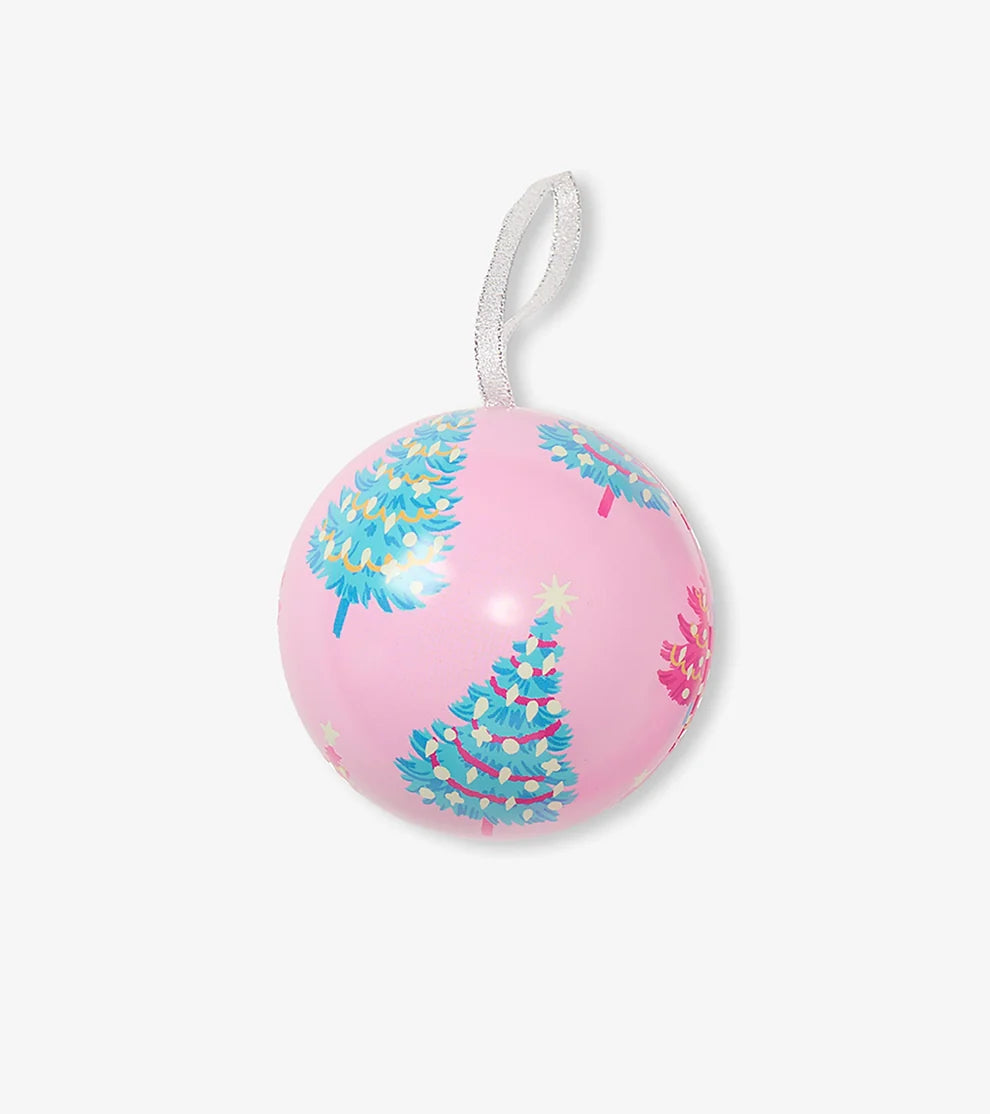 Pink ornament with blue and green tree designs on a white background