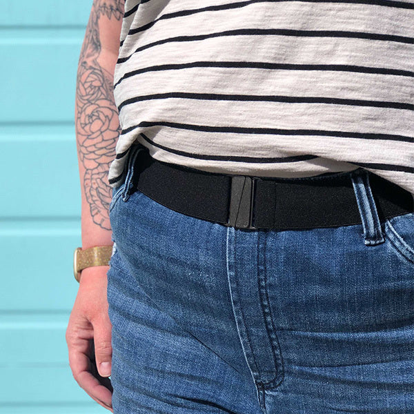 Person wearing a black belt with a blue background