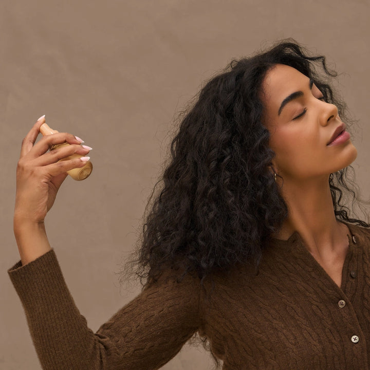 Woman holding a potato against a brown background