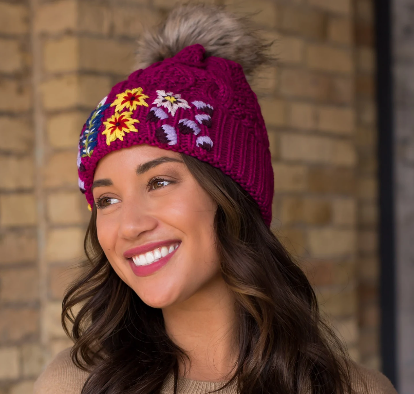 Magenta cable knit hat with hand stitched floral pattern