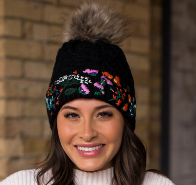 Black cable knit hat with hand stitched floral pattern